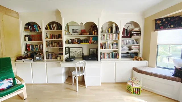 a view of a workspace with furniture and a potted plant