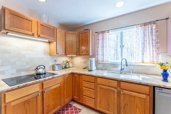 a large kitchen with stainless steel appliances lots of counter top space