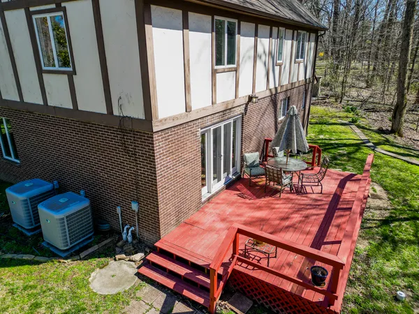 a view of a house with backyard and sitting area