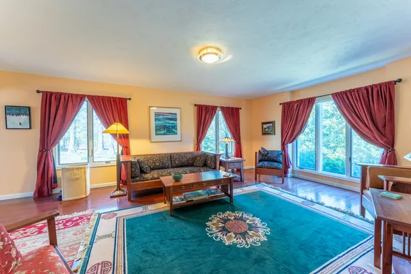a living room with furniture and a gaming machine