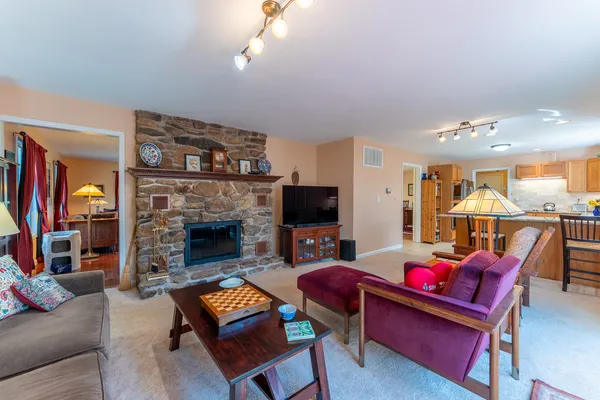 a living room with furniture and a kitchen view