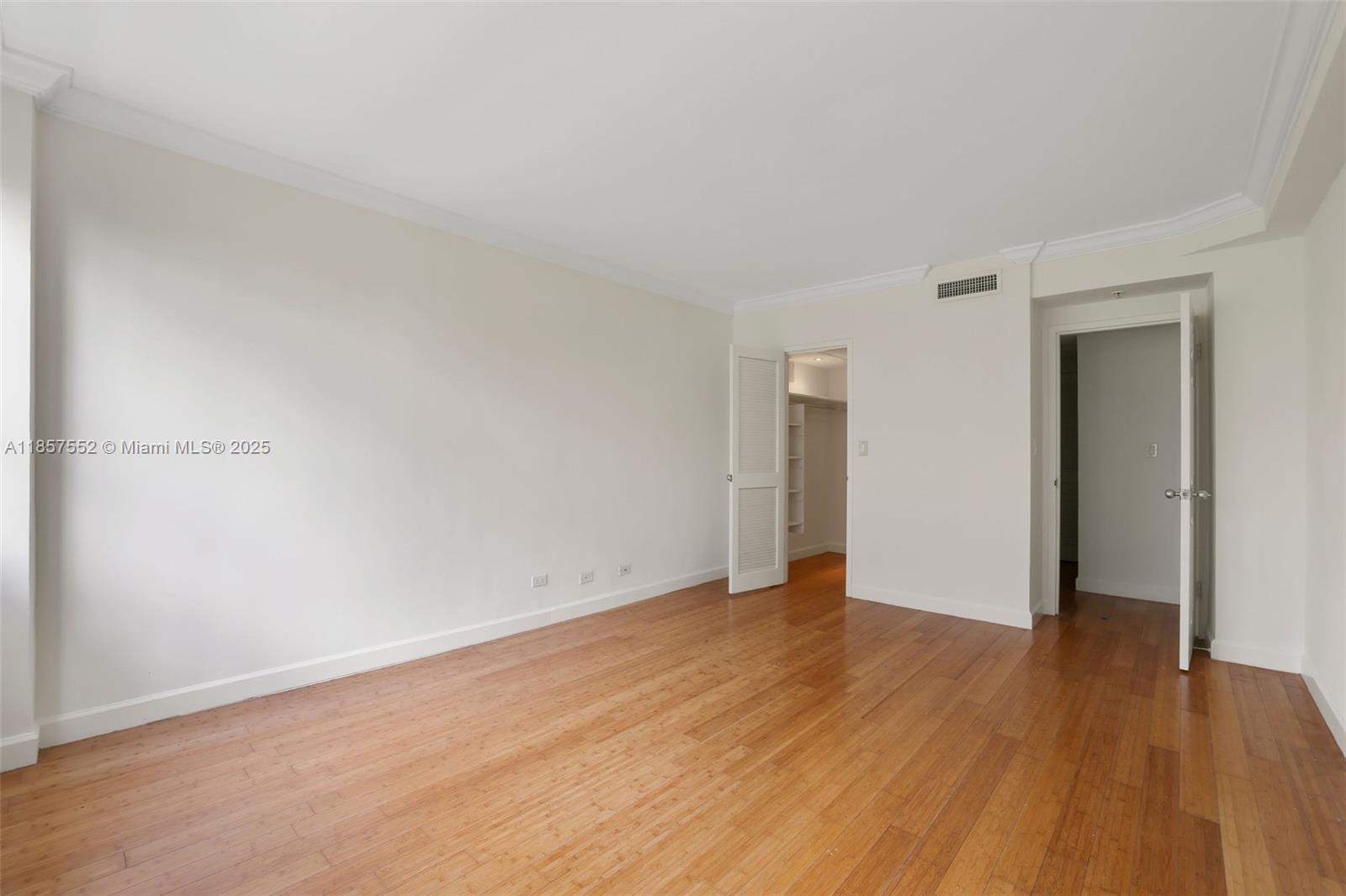 1500 Bay Road, Unit S0442 Miami Beach, FL 33139 - Photo 12 of 75 a view of an empty room with wooden floor and closet