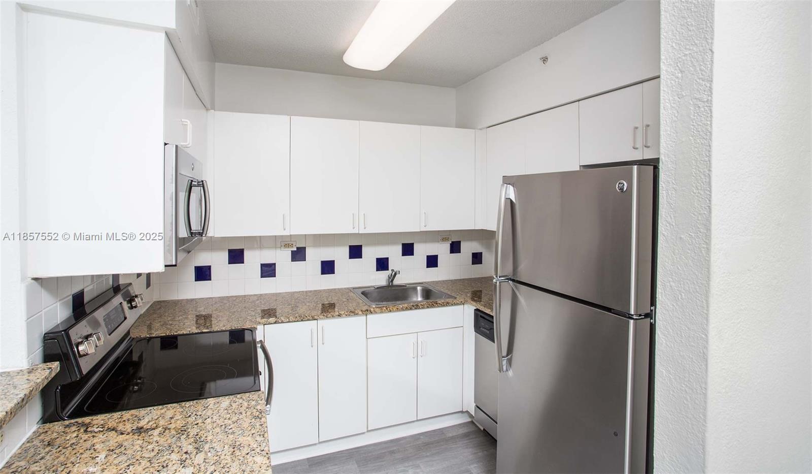 1500 Bay Road, Unit S0442 Miami Beach, FL 33139 - Photo 4 of 75 a kitchen with a refrigerator and a sink