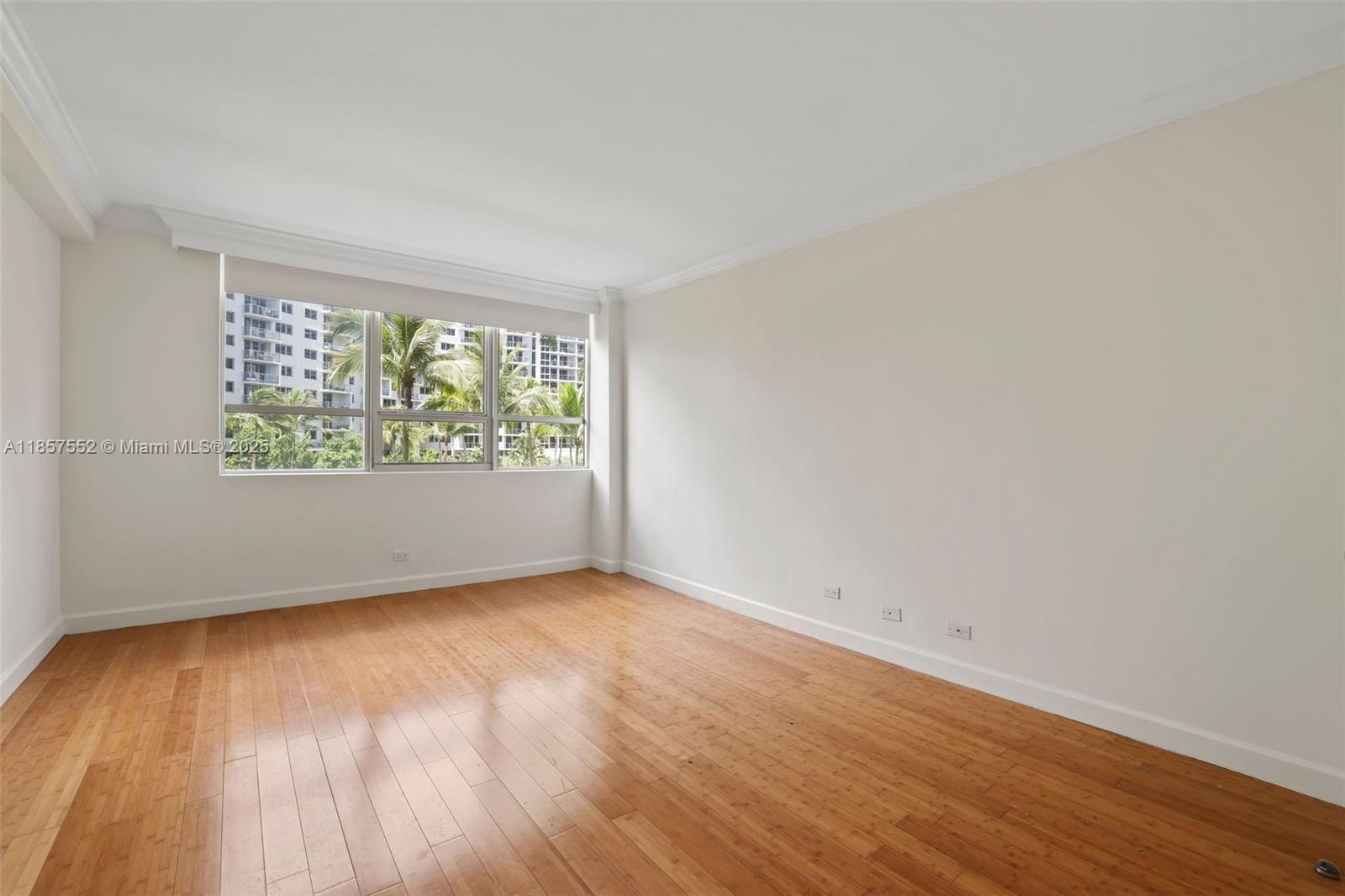1500 Bay Road, Unit S0442 Miami Beach, FL 33139 - Photo 9 of 75 an empty room with wooden floor and windows