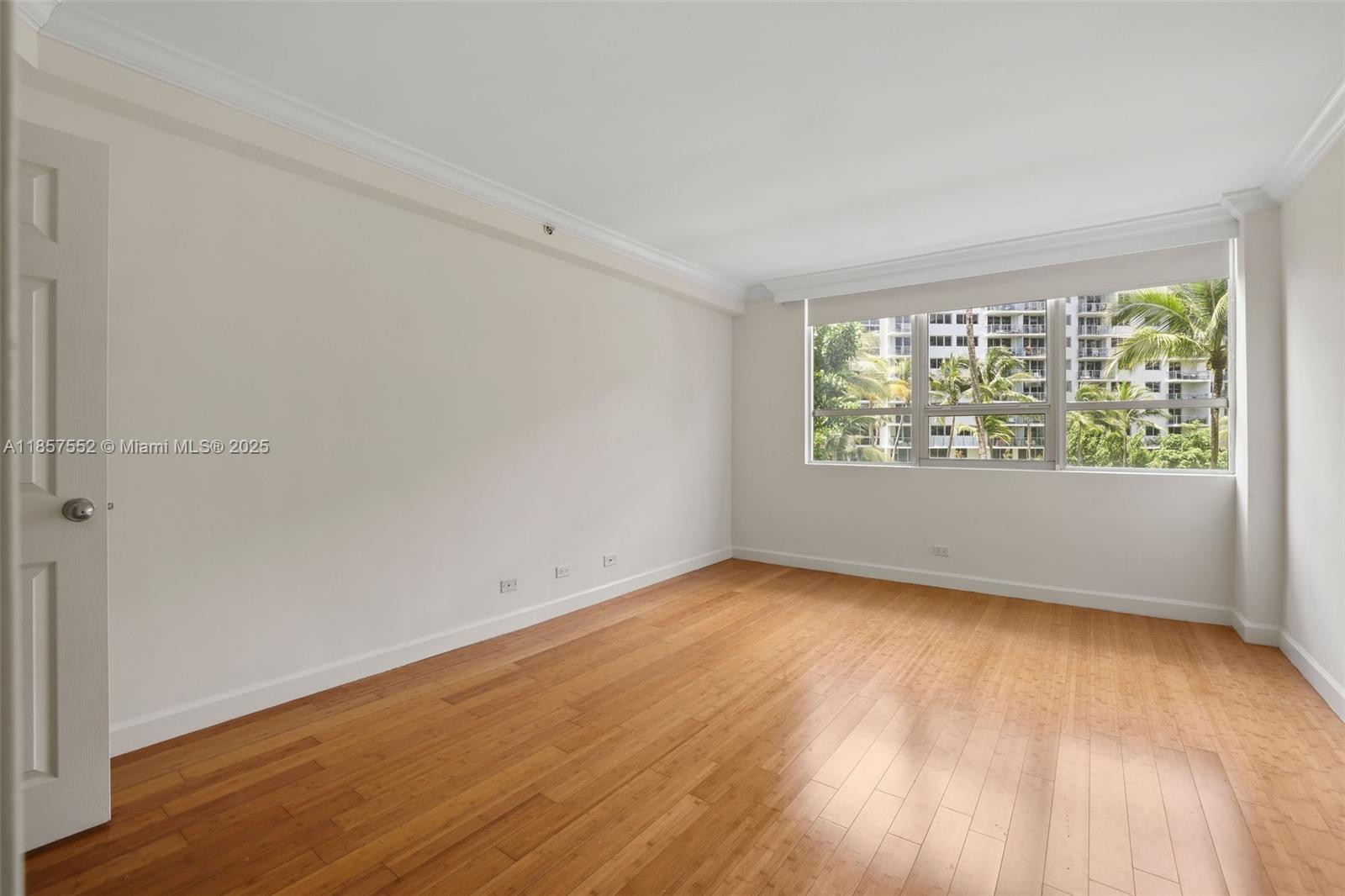 1500 Bay Road, Unit S0442 Miami Beach, FL 33139 - Photo 10 of 75 an empty room with wooden floor and windows