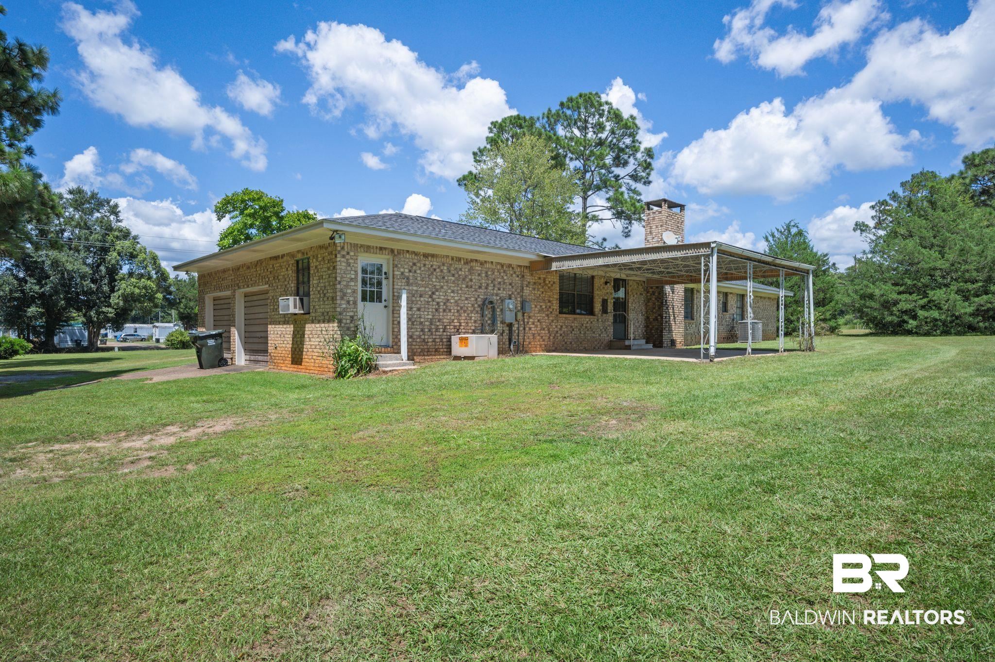 15880 Pine Grove Rd Extension West Bay Minette, AL 36507 - Photo 9 of 44 Rear view of house featuring a lawn