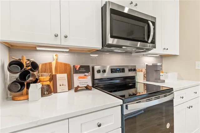 a kitchen with a stove and a microwave