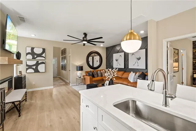 a living room with kitchen island furniture and a flat screen tv