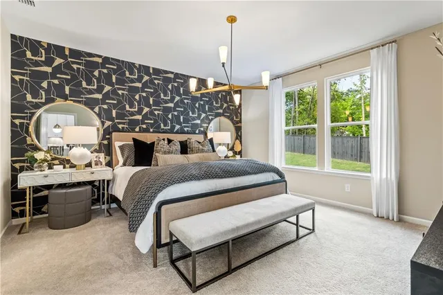 a spacious bedroom with a bed dresser and a window