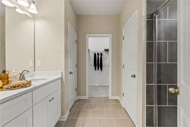 a bathroom with a sink a light fixture and a mirror