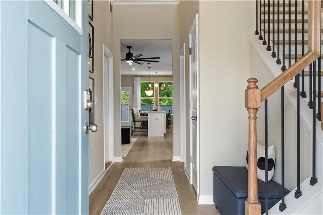 a view of a hallway with a livingroom and furniture