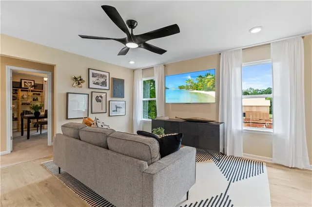 a bedroom with furniture and a large window