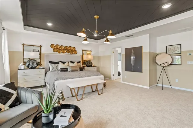 a large bedroom with a bed and lots of cabinets