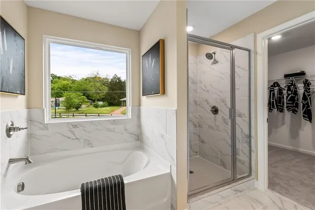 a view of walk in closet with clothes