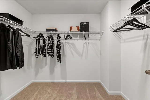 a en suite bathroom with a granite countertop sink a mirror and a shower