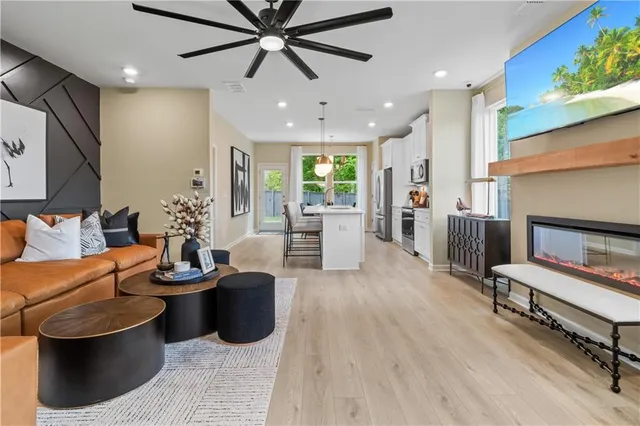 a living room with fireplace furniture and a wooden floor