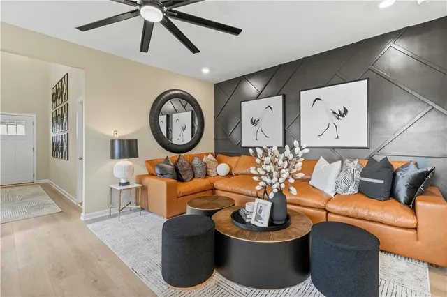 a living room with furniture a rug and white walls