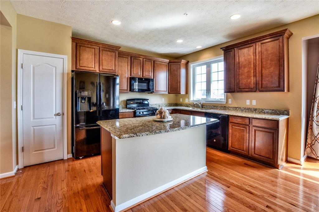 1 Truman Circle McKees Rocks, PA 15136 - Photo 3 of 25 Fully equipped kitchen with granite counters, upgraded cabinetry and all appliances.