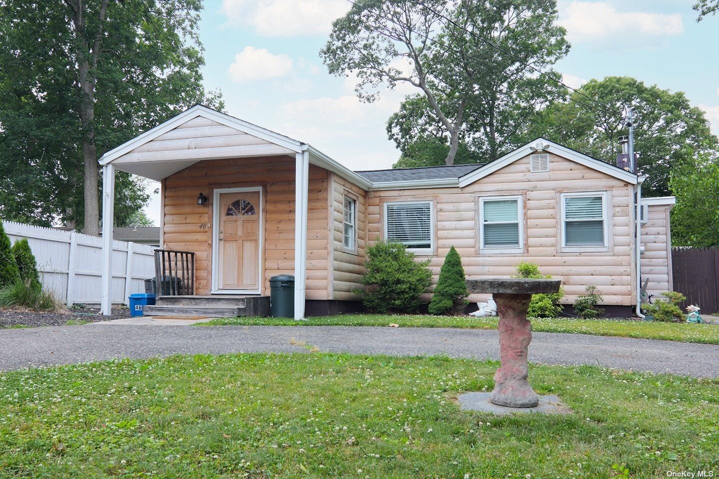46 Blue Point Road Selden, NY 11784 - Photo 1 of 1 a front view of a house with a yard and trees