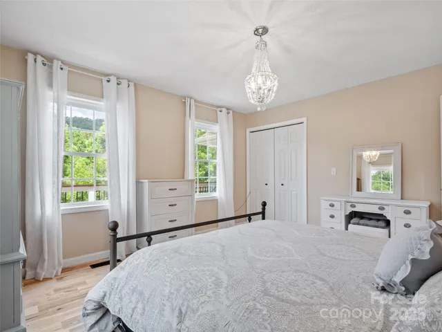 a spacious bedroom with a large bed and a window