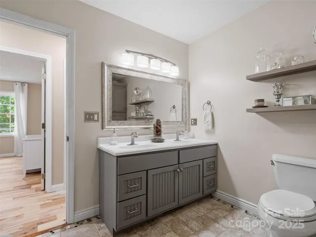 a bathroom with a toilet sink and mirror