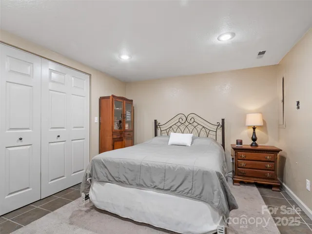 a bedroom with a bed and closet with lamp