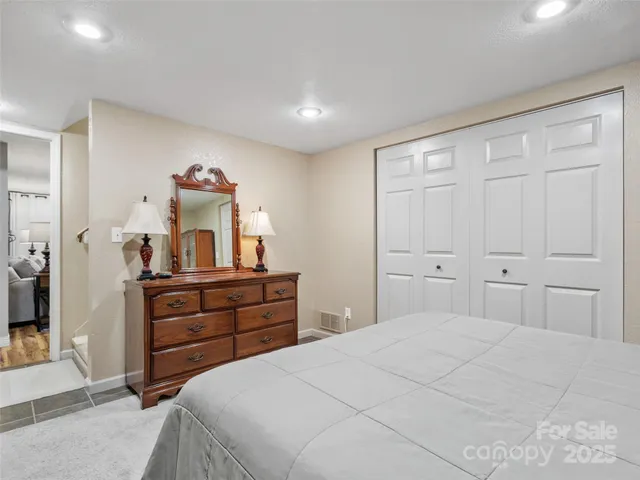 a bedroom with a bed and a mirror