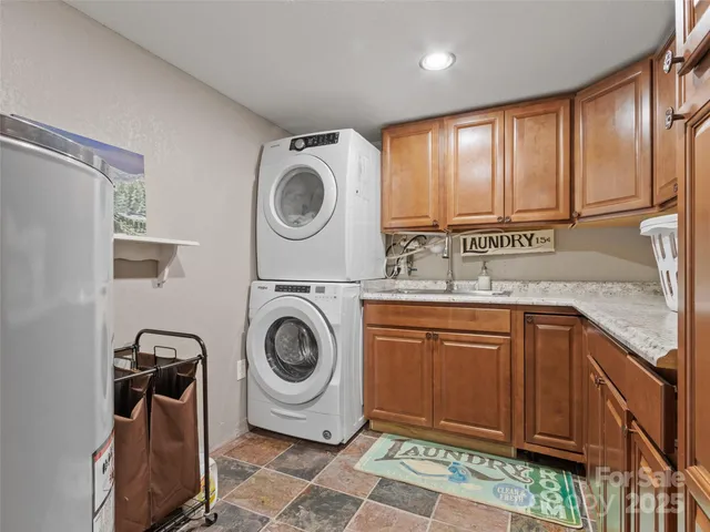 a utility room with sink dryer and washer