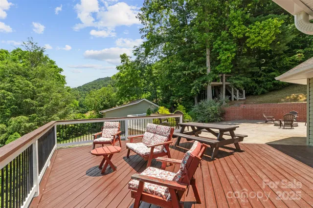a front view of a house with a garden and trees