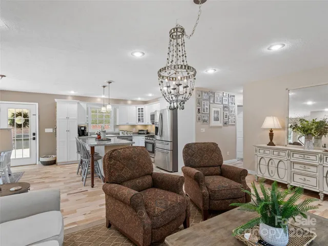a living room with furniture and a chandelier