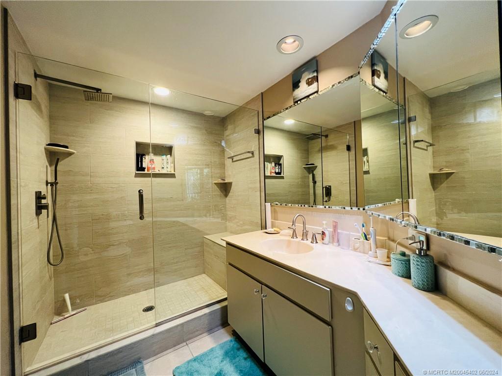 221 Northeast Plantation Road, Unit 215 Stuart, FL 34996 - Photo 36 of 83 a bathroom with a double vanity sink mirror and shower