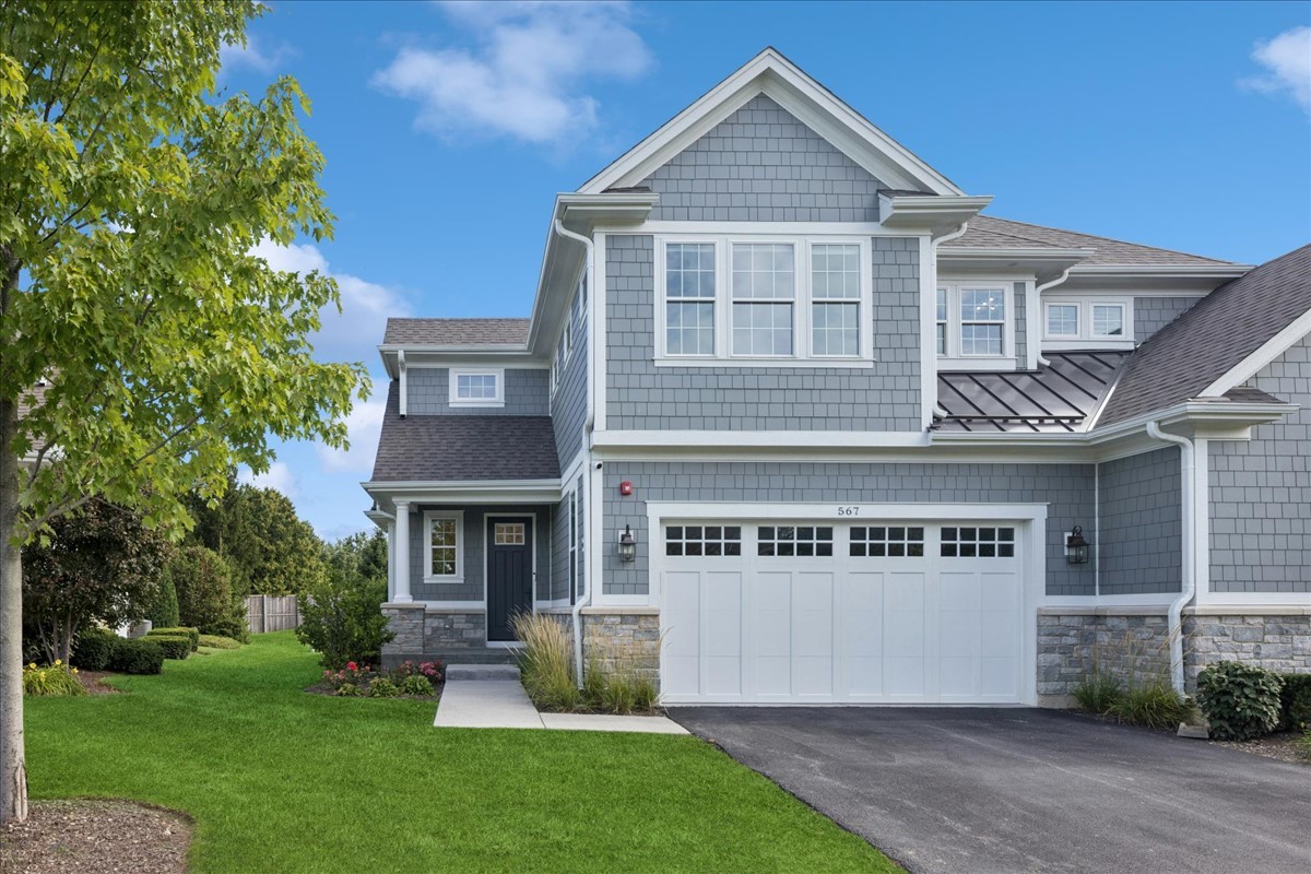 567 Hannah Lane Hinsdale, IL 60521 - Photo 1 of 33 a front view of a house with a yard and garage