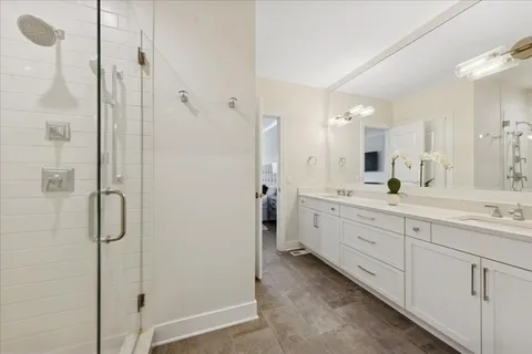 a spacious bathroom with a shower sink and mirror