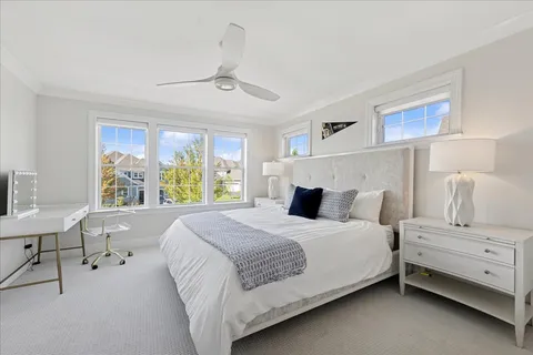 a bedroom with a large bed and a window