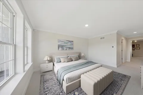 a bedroom with a bed and a painting on the wall