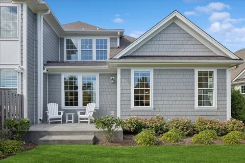 a front view of a house with porch and garden