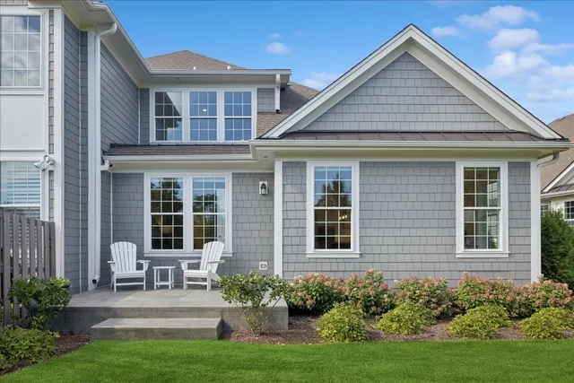 a front view of a house with porch and garden
