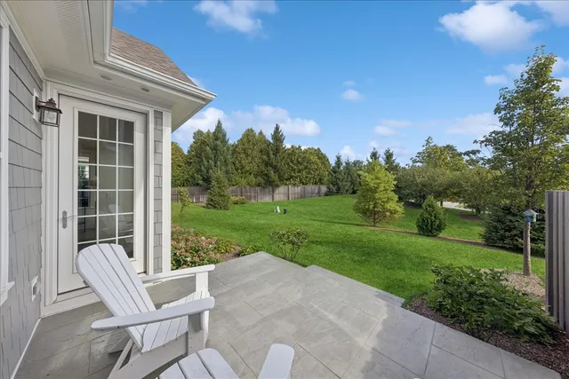 a view of a house with backyard and a garden