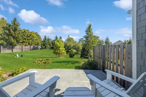 a view of a chairs and table on the garden