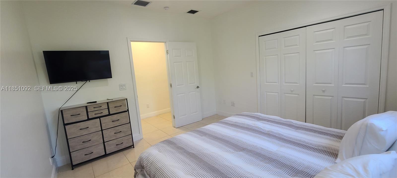 1721 Southwest 24th Terrace Miami, FL 33145 - Photo 34 of 80 a bedroom with a bed and a television