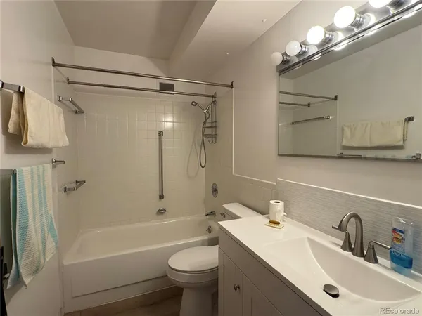 a bathroom with a sink toilet tub and shower