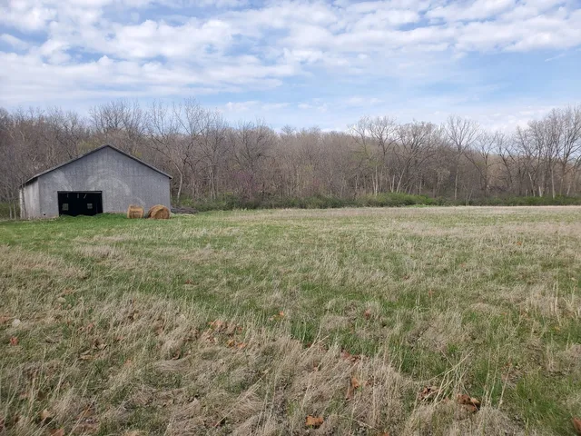 a big house with a big yard and large trees