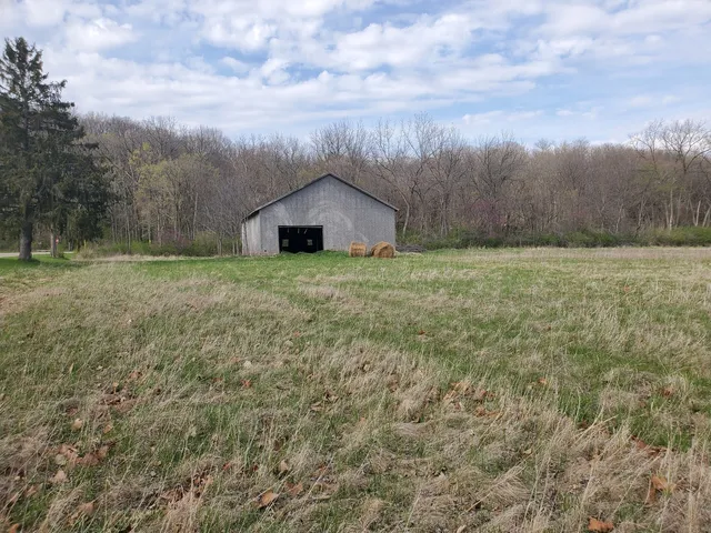 a big house with a big yard and large trees