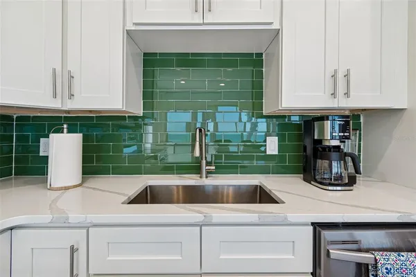 a kitchen with kitchen island wooden cabinets a refrigerator a stove a microwave oven with a dining table and chairs