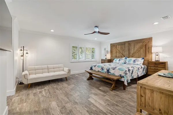 a bedroom with a bed and a painting on the wall