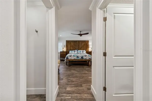 a view of a white house with a yard and potted plants