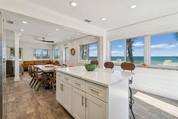 a kitchen with a refrigerator and a stove top oven