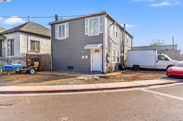 a view of a house with a yard and sitting area