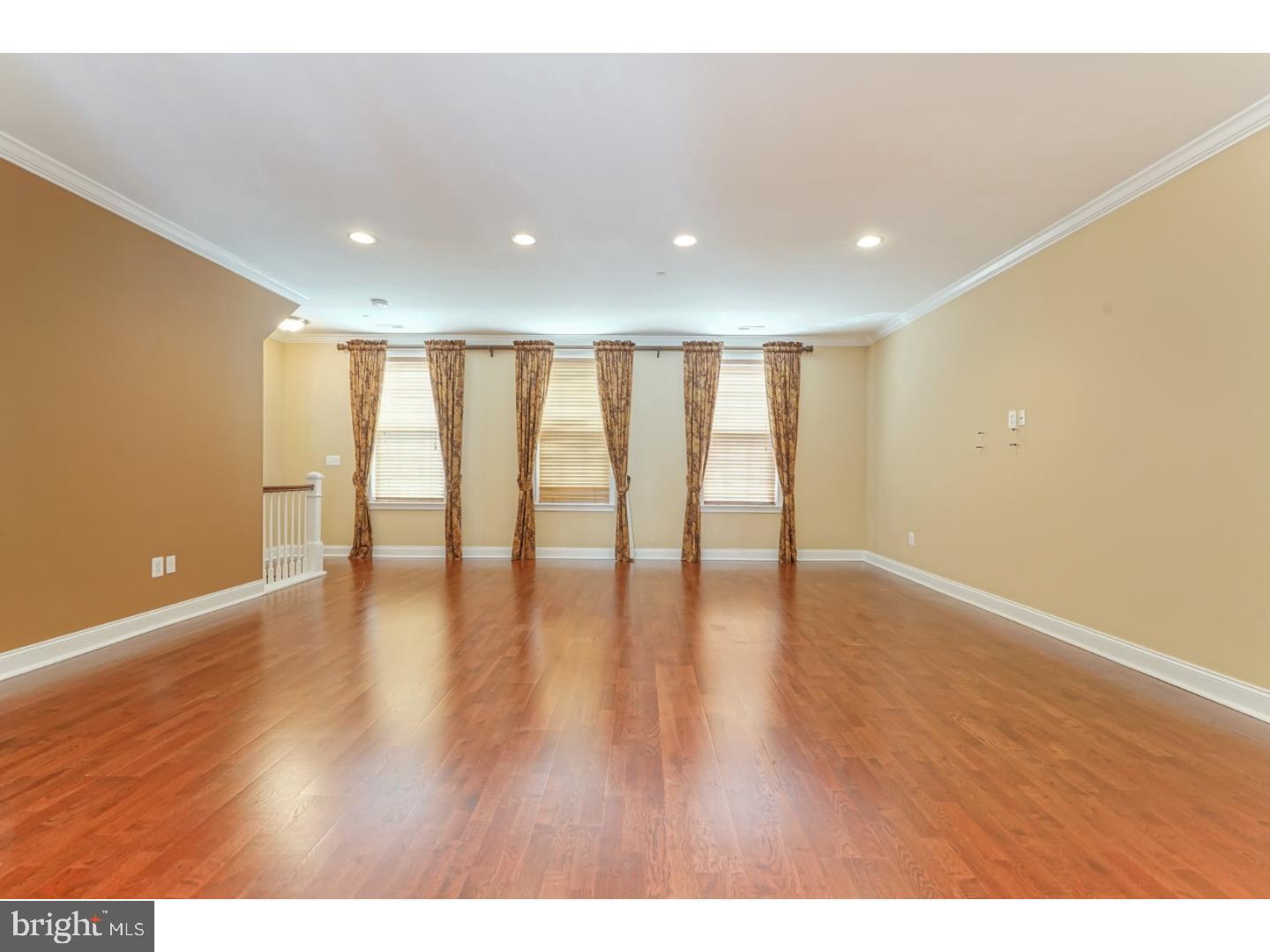508 Captains Way Philadelphia, PA 19146 - Photo 3 of 25 a view of an empty room with wooden floor and a window