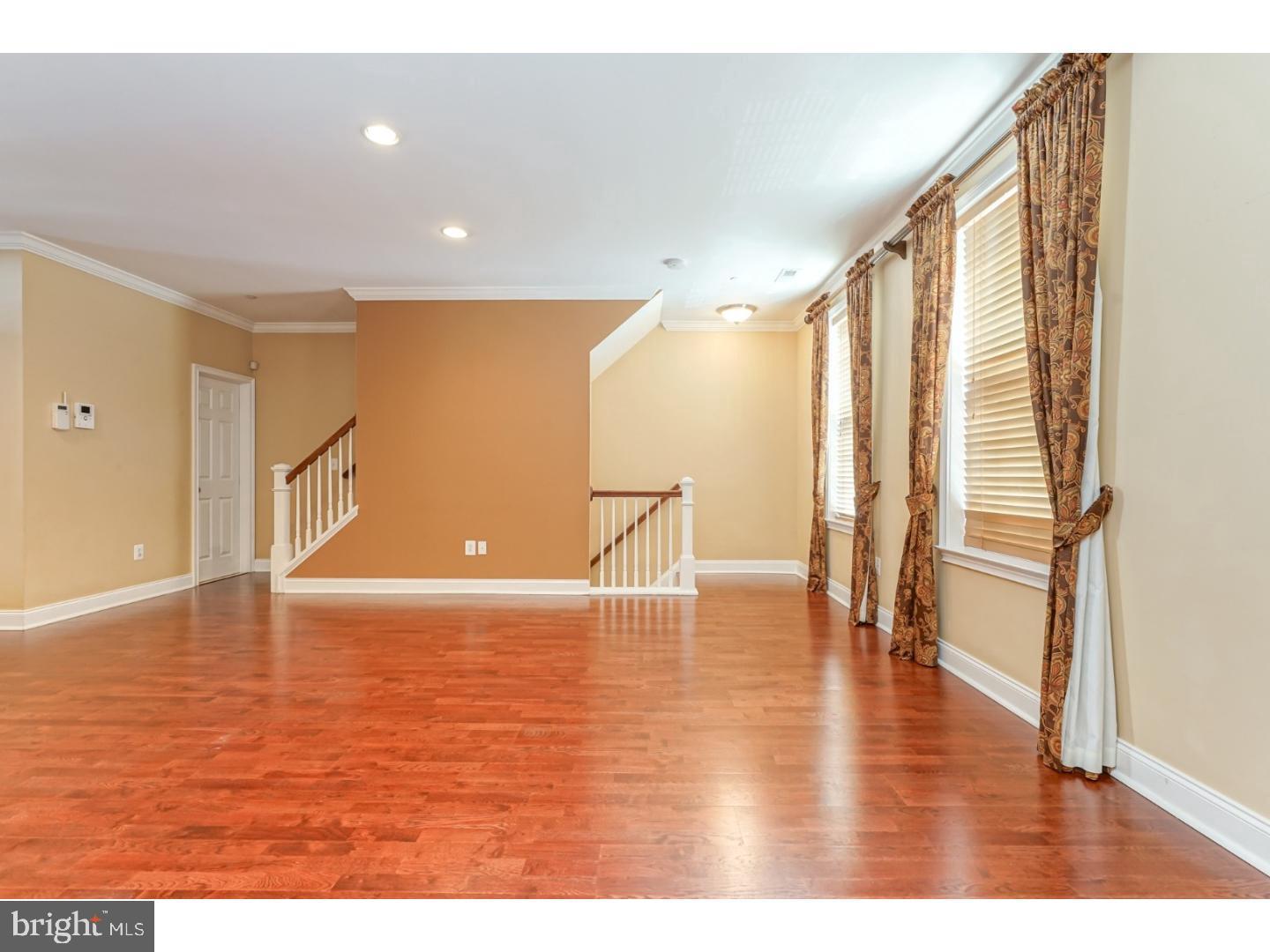 508 Captains Way Philadelphia, PA 19146 - Photo 5 of 25 a view of an empty room with wooden floor and a window